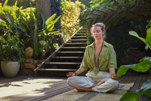 Young woman practicing yoga in the middle of nature